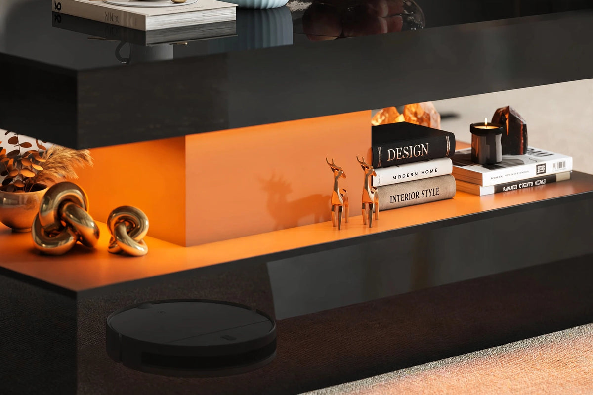 Close-up of coffee table middle tier with warm LED lighting, design books and gold deer figurines on display