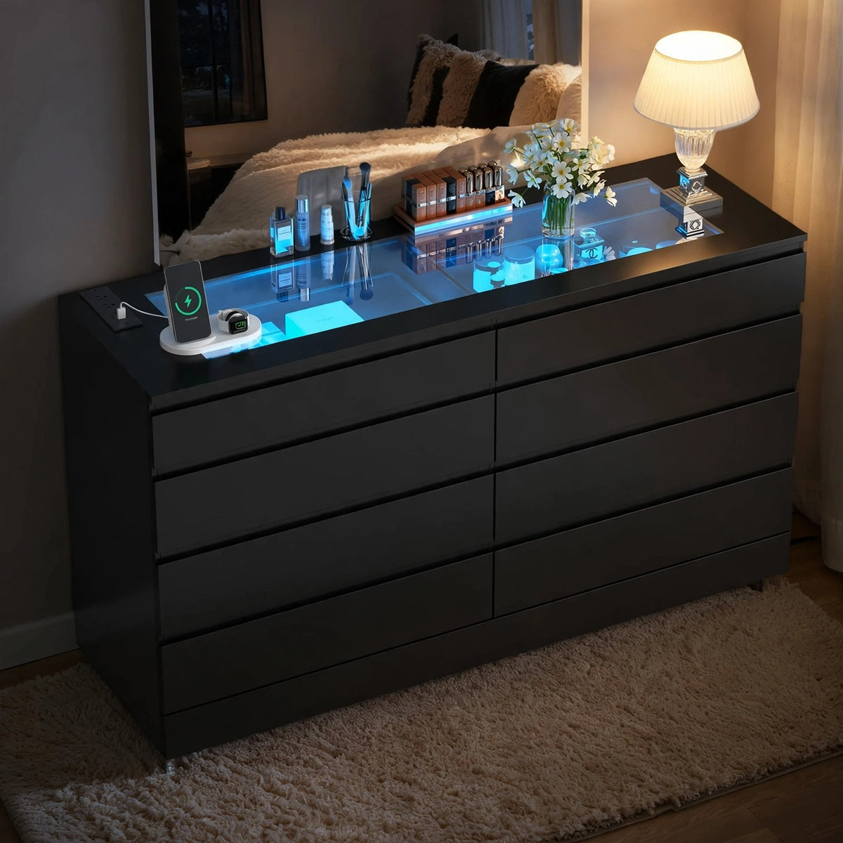 Black smart dresser with glowing blue LED glass top display and wireless charging station in cozy evening bedroom setting