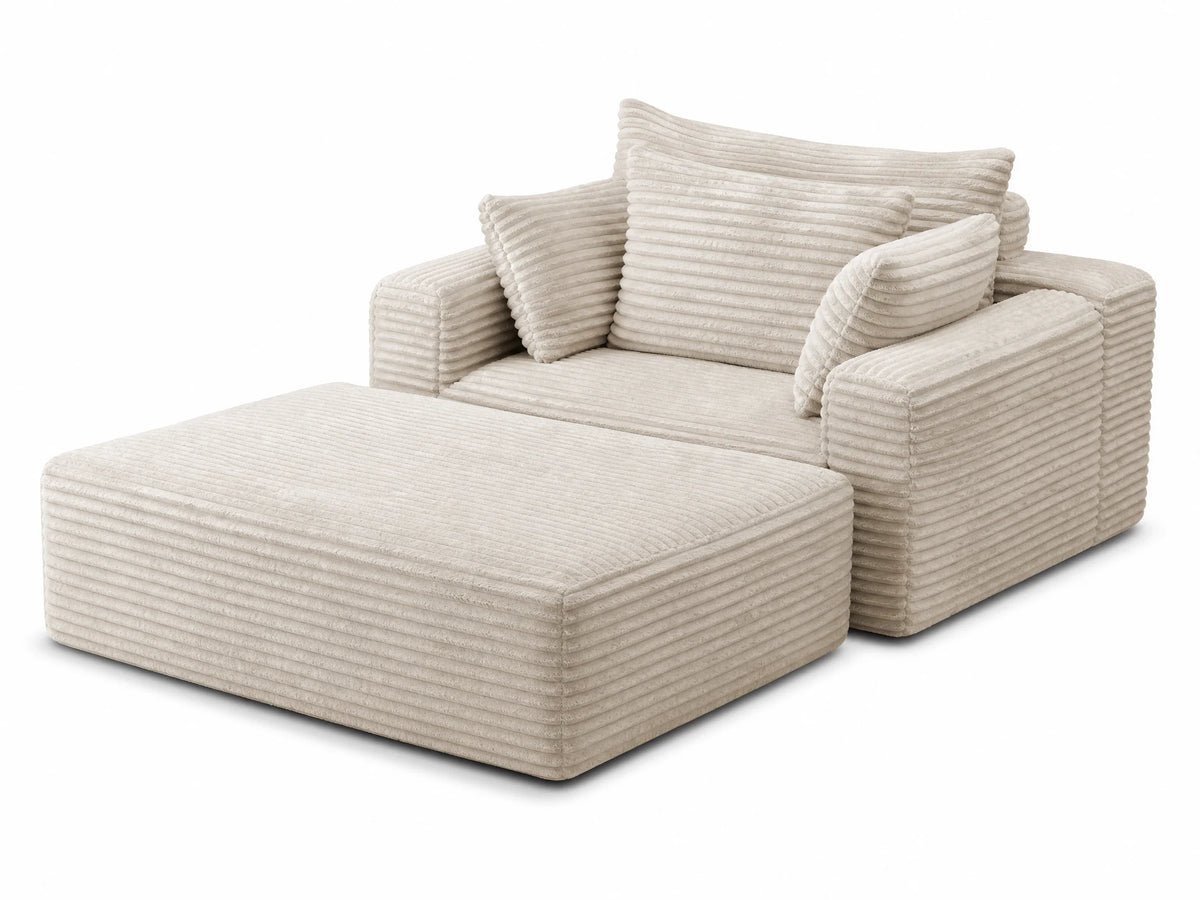 Oversized cloud sofa with ottoman in bright modern living room with plants and shelves